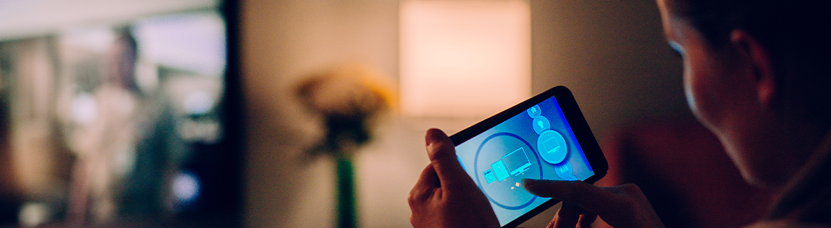 Woman on her mobile device researching audience measurement solutions relevant to cross-media measurement.