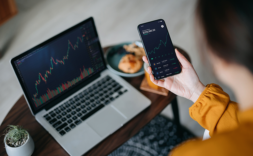 Marketer reviewing tailored insights on Nielsen's media planning solutions on a phone and laptop.